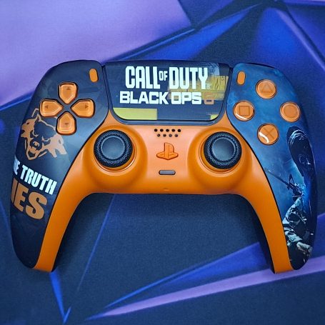 A customised orange game controller featuring "Call of Duty: Black Ops" design.